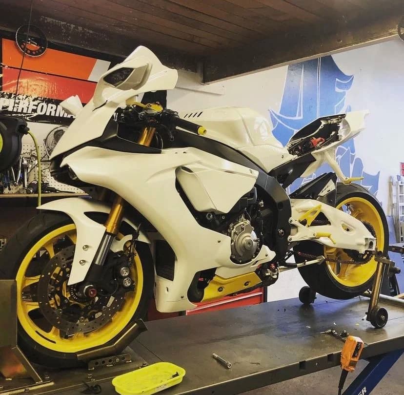 Custom white sport motorcycle inside the AE Kustomz workshop