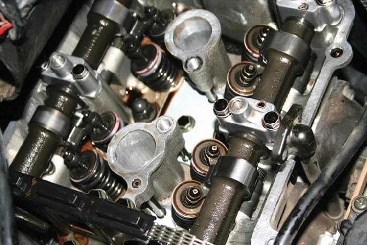 Motorcycle engine valve train opened for a clearance inspection